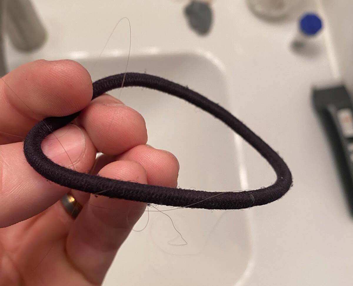 An inferior hair tie ripping your hair out.