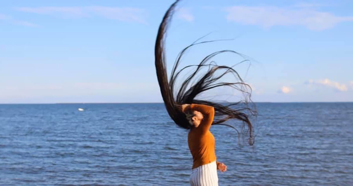 Zahab Khan throwing a legendary six-foot hairwhip in front of the ocean