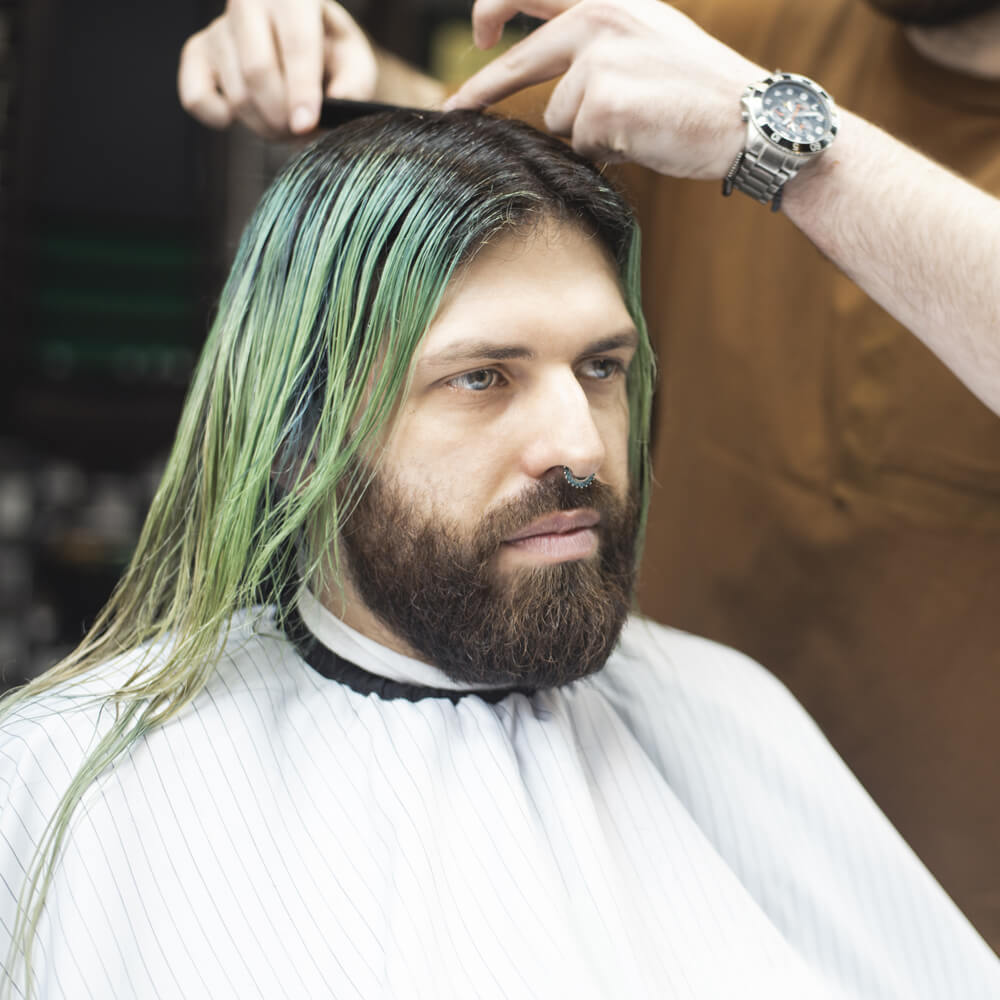 "A man getting his hair dyed in a blog post answering, "should you color your hair?"