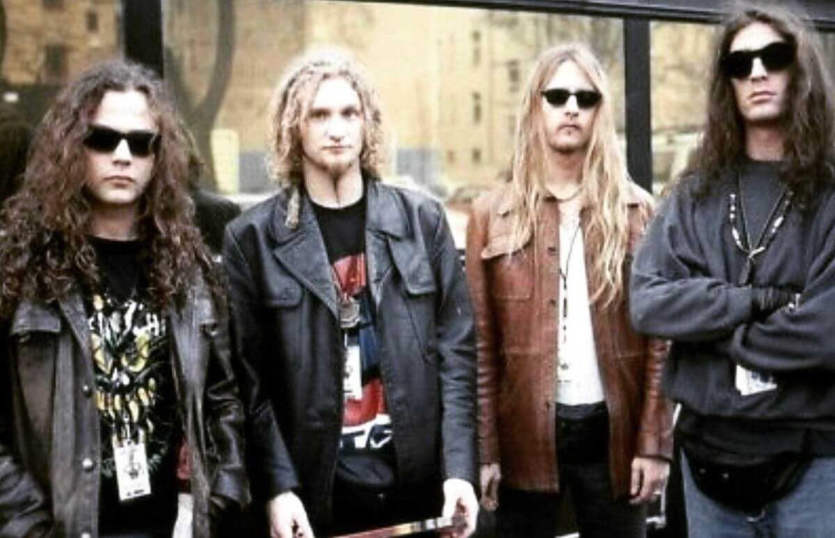 All 4 Alice in Chains band members standing side by side, 3 with sunglasses and 1 without, big long manes, 2 blonde, and 2 brunettefeatured in the Best Hair in Rock and Roll.