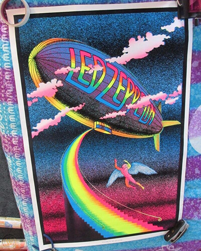 A rainbow painting an angel ascending the stairway to heaven leading to the Mothership Led Zeppelin blimpfeatured in the Best Hair in Rock and Roll.