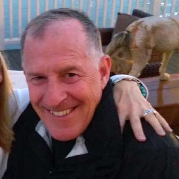 Chuck’s Uncle Jay looking directly into the camera, with his big 65% bald dome shining. A slim peninsula of hair can be seen going straight down the middle of his head.
