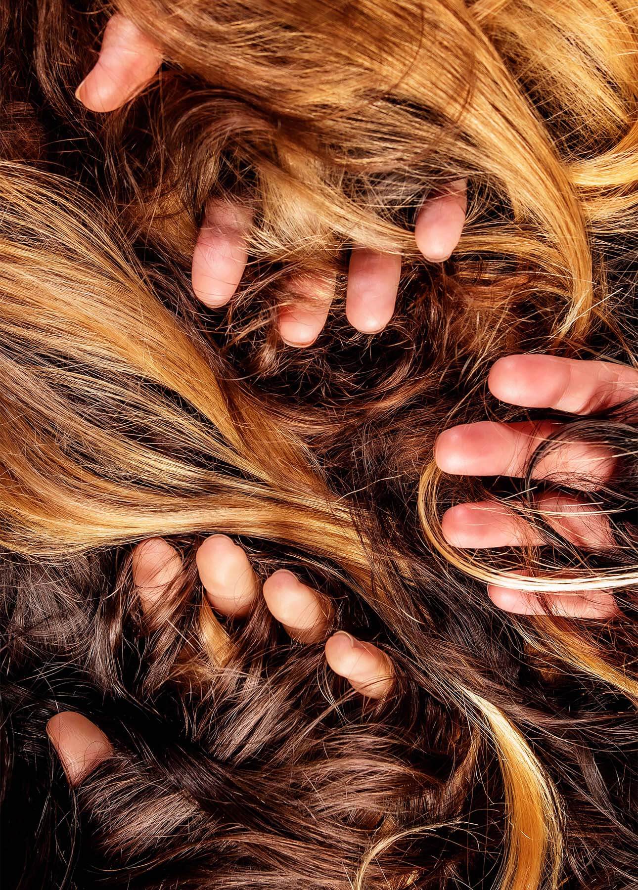 A mix of hair with fingers coming through 