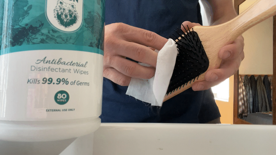 Cleaning The Continental paddle brush with disinfectant wipes