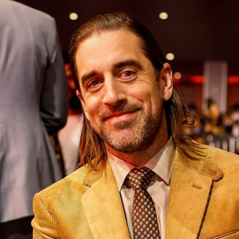 Aaron Rodgers with hair slicked back down to his shoulders