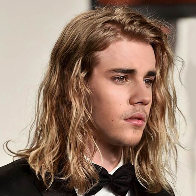 Justin Bieber with shaggy long blonde hair