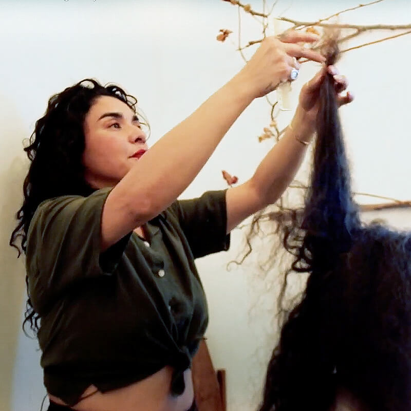 Naomi trimming the curly hair