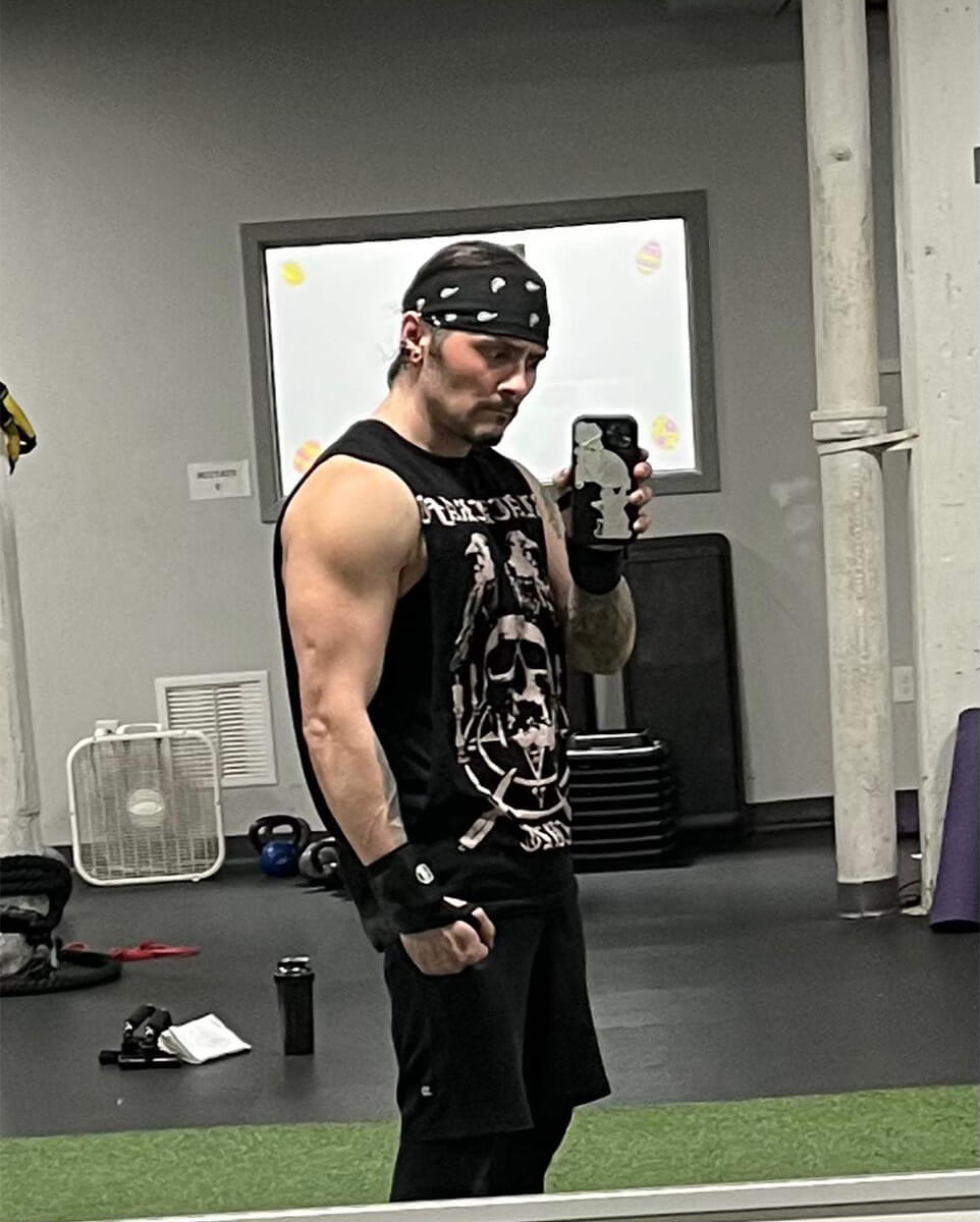 Danny D looking BUFF in the gym mirror, post transformation.