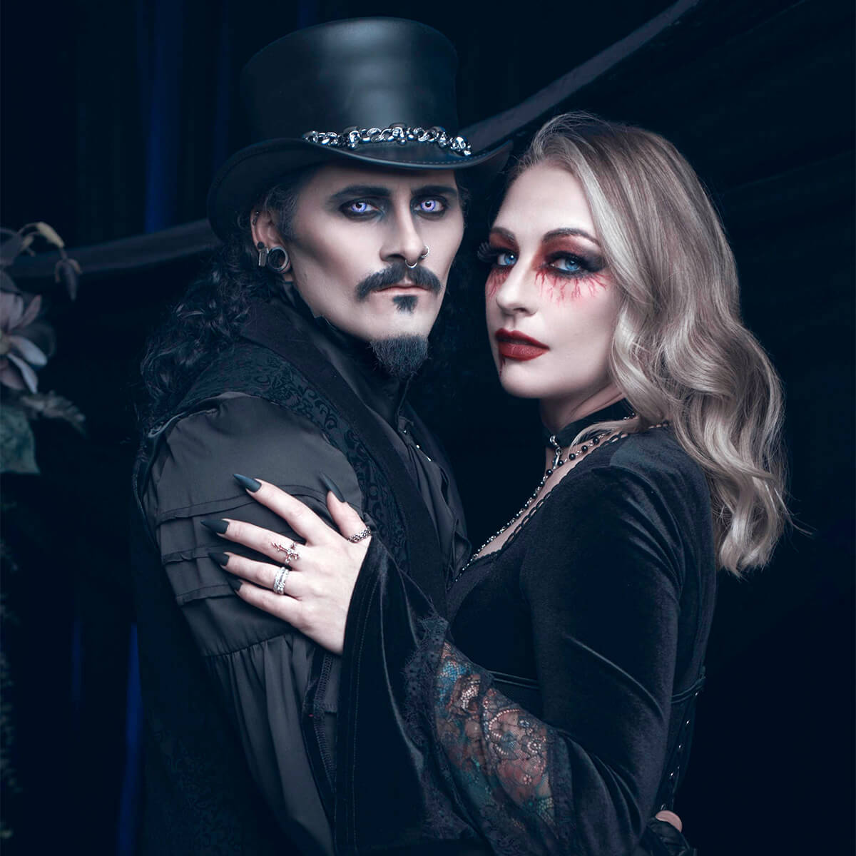 Danny D posing with his wife, both all decked out in SERIOUS vampire attire.