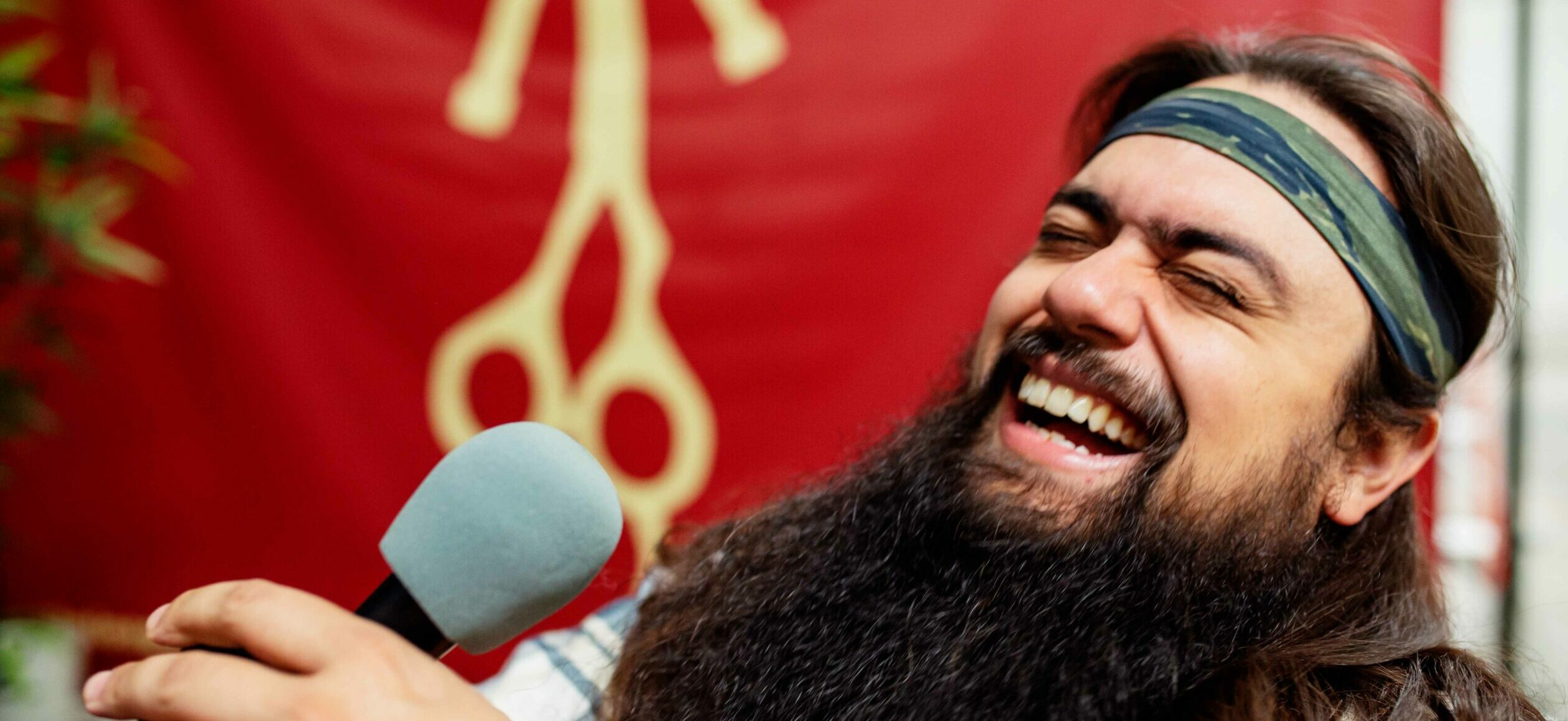 Jose Mejia laughing while on The Longhairs Podcast Let It Ride