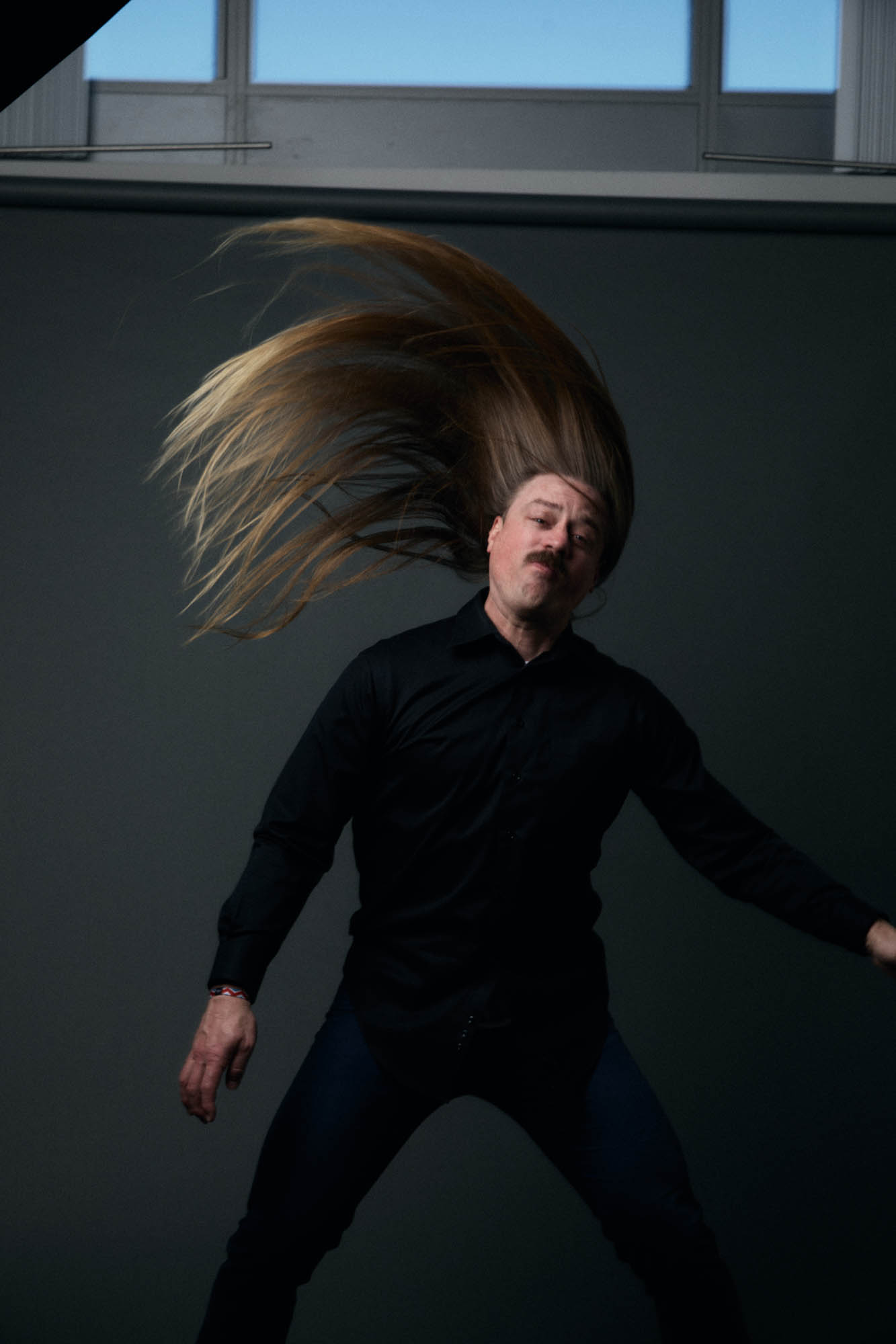 Chris Healy of The Longhairs whipping his hair aggressively. By Erica Joan 2024.